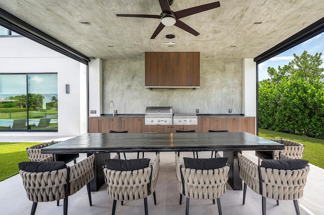 view of patio / terrace featuring area for grilling, ceiling fan, a grill, and an outdoor bar