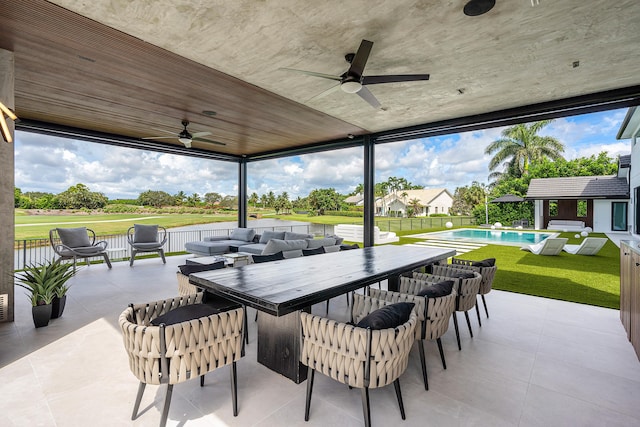 view of patio featuring ceiling fan, outdoor lounge area, and a fenced in pool