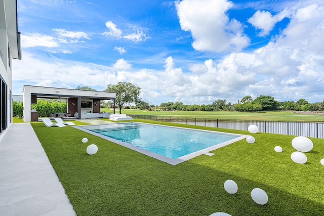 view of pool featuring a lawn