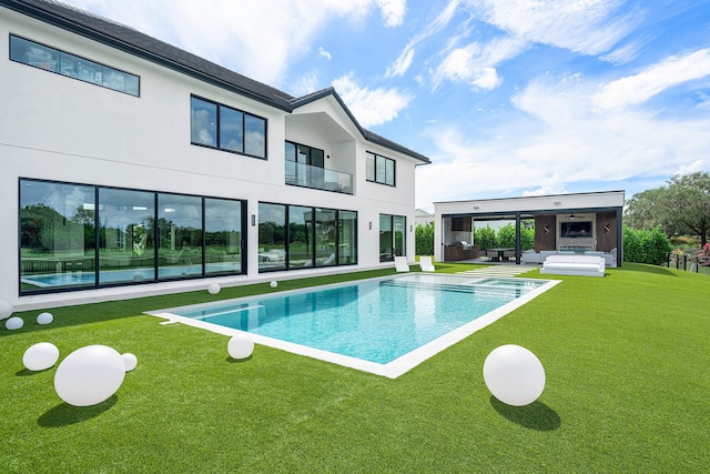 view of pool with a patio and a lawn