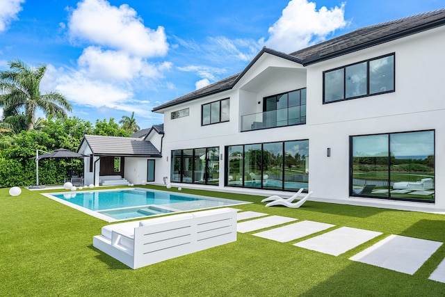 rear view of property with a patio and a yard