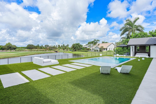 view of swimming pool featuring a yard