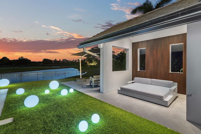 patio terrace at dusk featuring outdoor lounge area