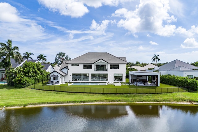 rear view of property featuring a water view, a yard, and a gazebo