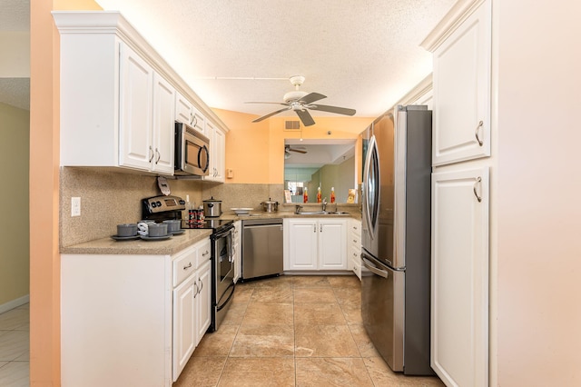 kitchen featuring light tile patterned floors, stainless steel appliances, ceiling fan, and decorative backsplash