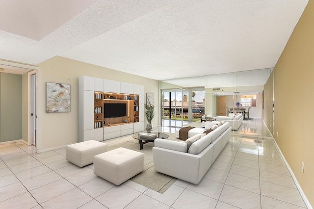 living room featuring a textured ceiling and light tile patterned floors