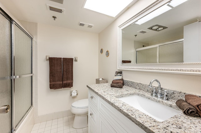 full bathroom featuring tile patterned flooring, vanity, toilet, and enclosed tub / shower combo