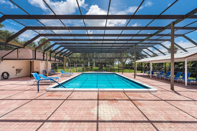 view of pool with a lanai and a patio