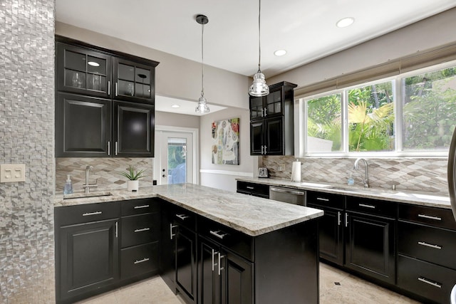 kitchen with pendant lighting, decorative backsplash, and sink