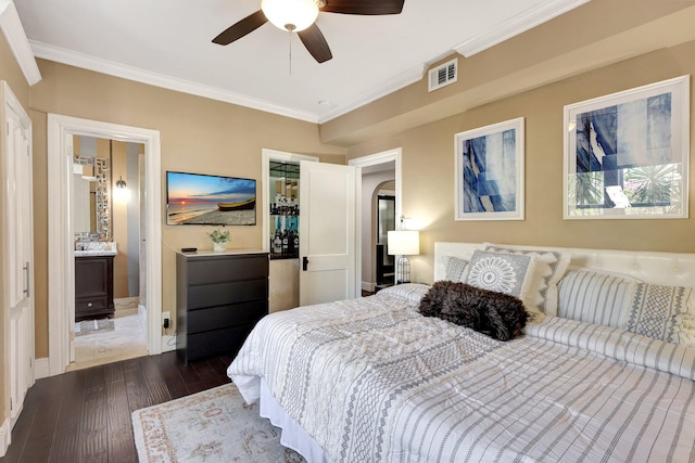 bedroom with ceiling fan, connected bathroom, dark hardwood / wood-style floors, and ornamental molding