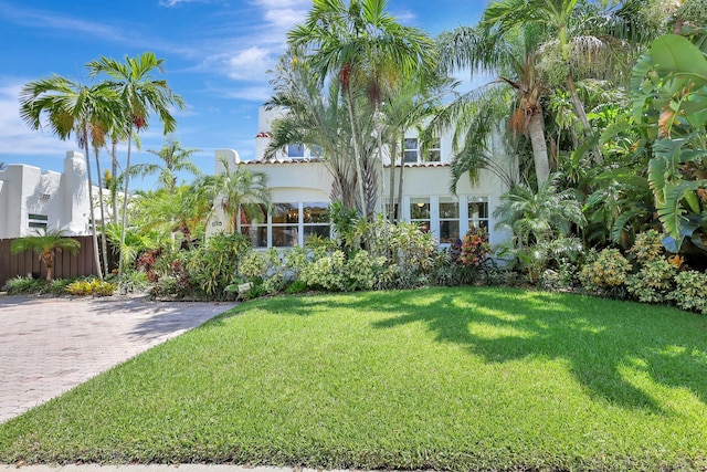 mediterranean / spanish house with a front lawn