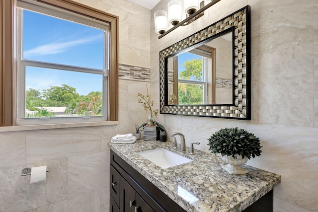 bathroom with tile walls and vanity