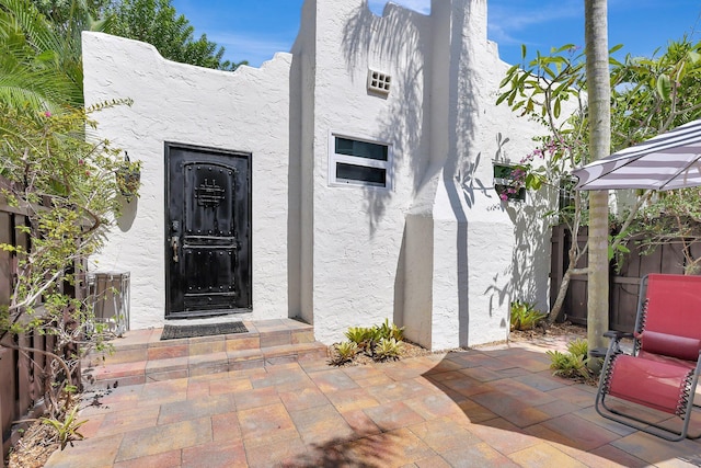 doorway to property with a patio area