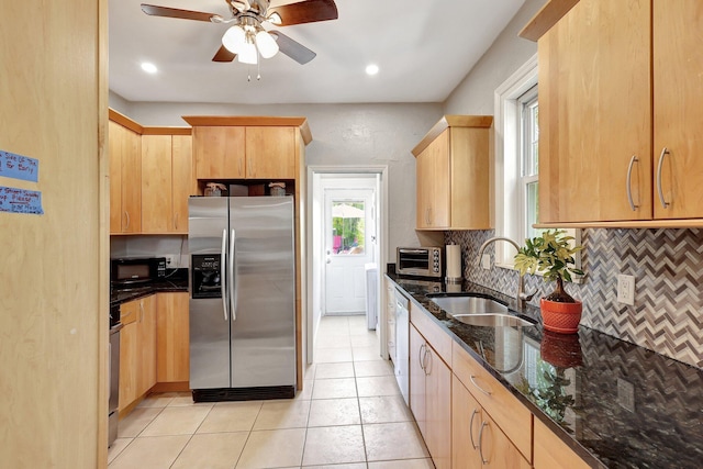 kitchen featuring ceiling fan, light brown cabinetry, stainless steel appliances, and sink