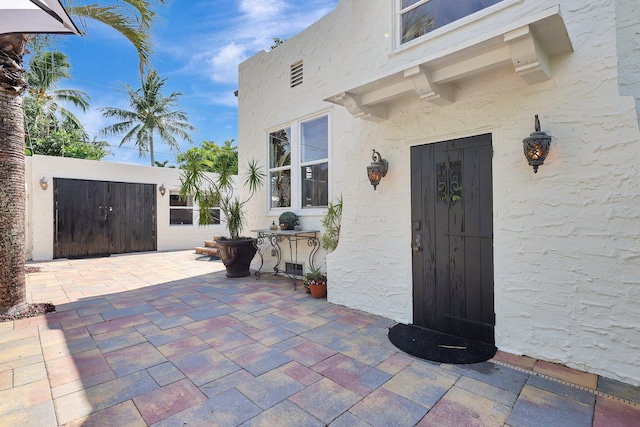 entrance to property featuring a patio area