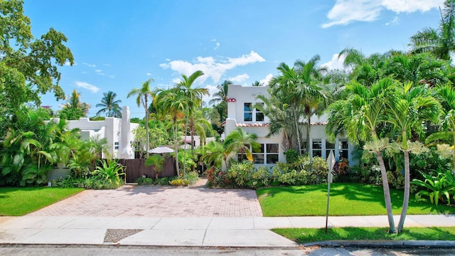 mediterranean / spanish-style home featuring a front yard