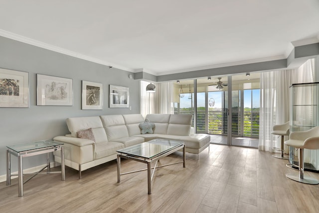 living room with ornamental molding, ceiling fan, and light wood-type flooring