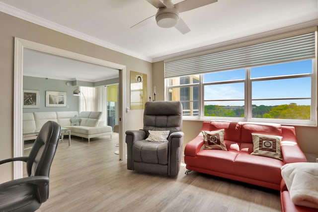 living room with ceiling fan, crown molding, and hardwood / wood-style flooring