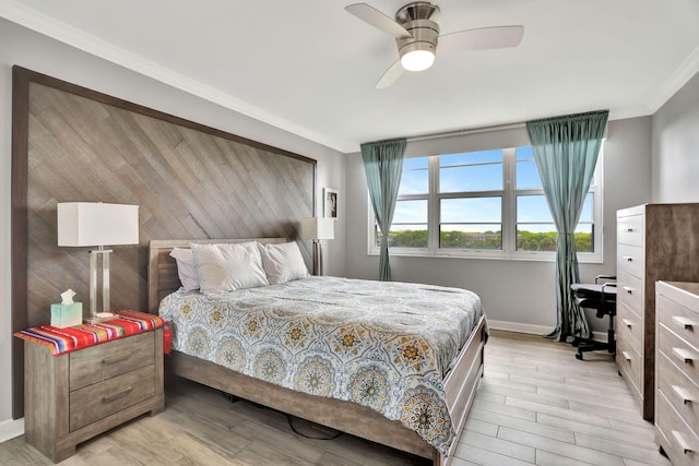 bedroom featuring ornamental molding, ceiling fan, and light wood-type flooring