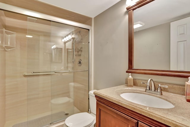 bathroom with a shower with door, toilet, and vanity