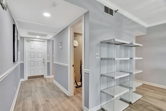 hall featuring crown molding and light wood-type flooring