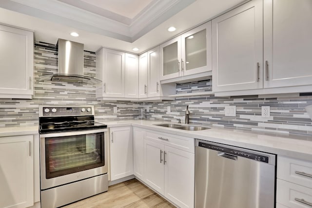 kitchen with sink, wall chimney exhaust hood, tasteful backsplash, and stainless steel appliances