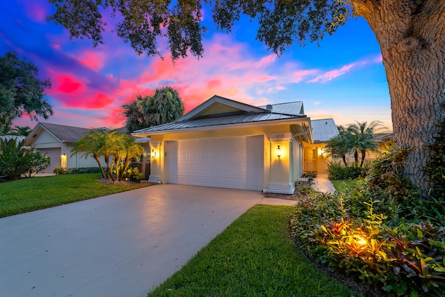 view of front of property with a lawn and a garage