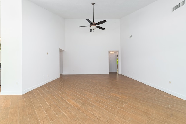 unfurnished living room featuring ceiling fan, high vaulted ceiling, and light hardwood / wood-style flooring