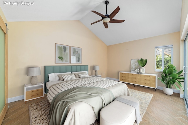 bedroom with ceiling fan, lofted ceiling, and hardwood / wood-style flooring