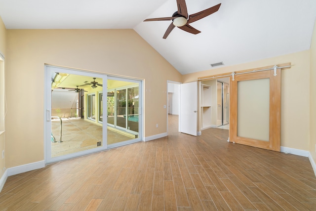 interior space with light hardwood / wood-style flooring, ceiling fan, and high vaulted ceiling