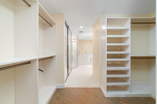 walk in closet featuring light hardwood / wood-style floors