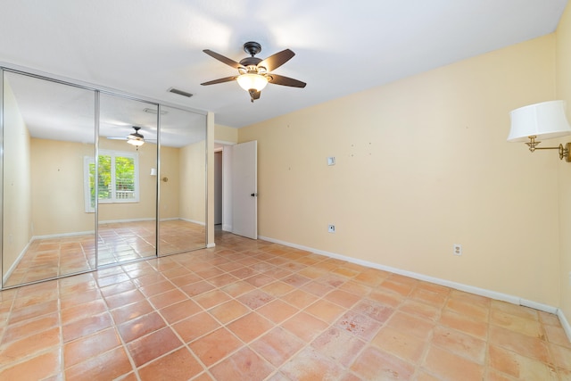 unfurnished bedroom featuring a closet, ceiling fan, and tile patterned flooring