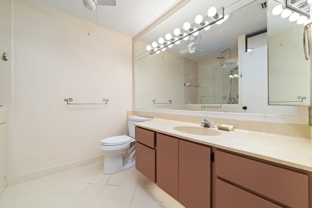 bathroom featuring toilet, vanity, ceiling fan, and tile patterned flooring