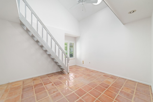 tiled entrance foyer featuring ceiling fan and high vaulted ceiling