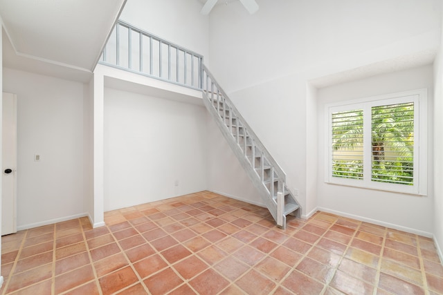 staircase featuring ceiling fan and tile patterned floors