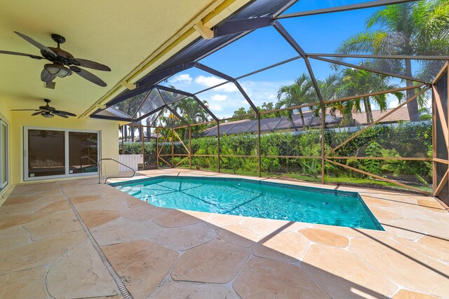 view of pool featuring ceiling fan, a lanai, and a patio area