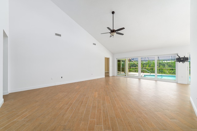 unfurnished living room with ceiling fan, high vaulted ceiling, and light hardwood / wood-style floors