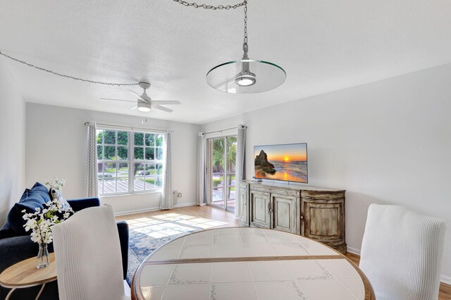 bedroom with access to outside, a textured ceiling, and light hardwood / wood-style floors