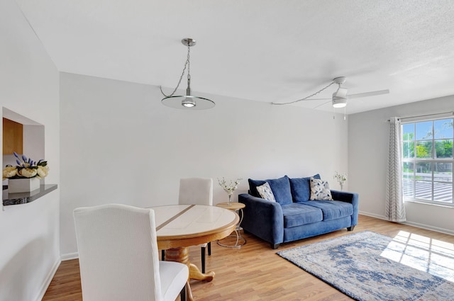 living room featuring ceiling fan and hardwood / wood-style flooring