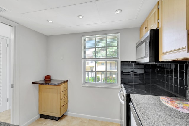 kitchen featuring backsplash, light tile patterned floors, light brown cabinets, and stainless steel range with electric cooktop