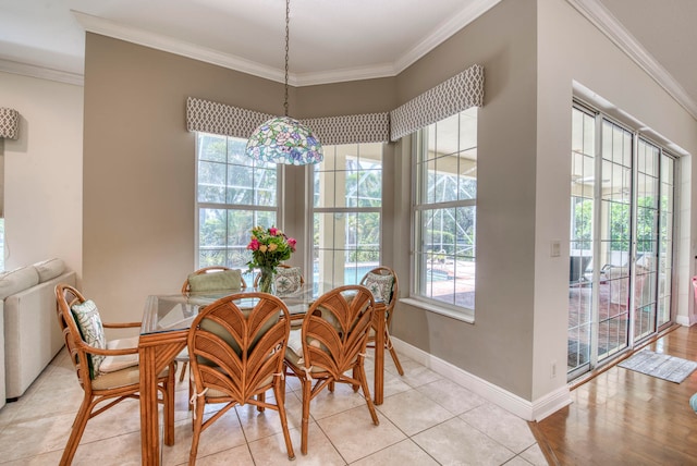 dining area with light hardwood / wood-style flooring and crown molding