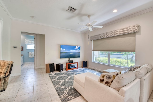 living room with light tile patterned floors, ceiling fan, and crown molding