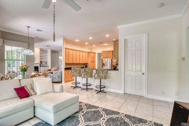 tiled living room with ornamental molding and ceiling fan