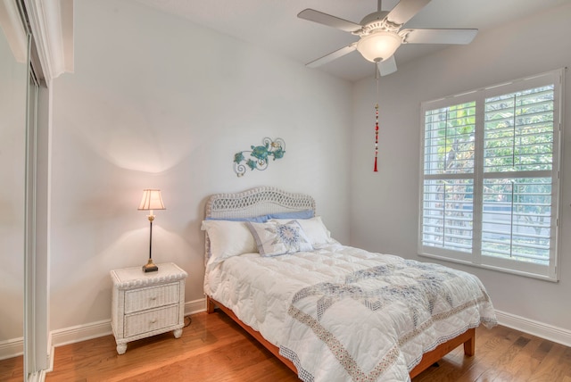 bedroom with hardwood / wood-style floors and ceiling fan