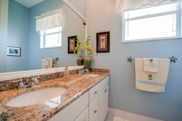 bathroom with dual vanity and tile patterned floors