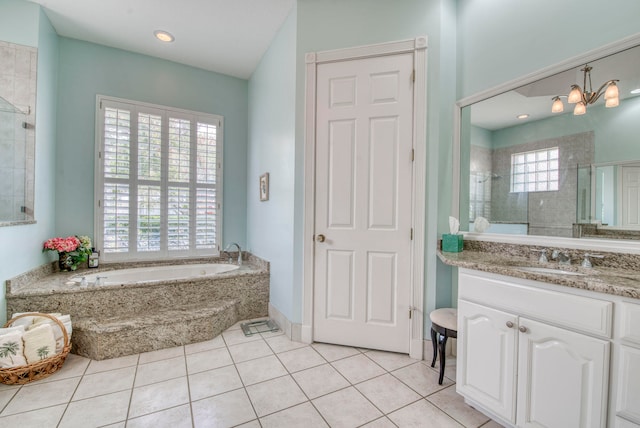 bathroom featuring a notable chandelier, vanity, independent shower and bath, and tile patterned flooring