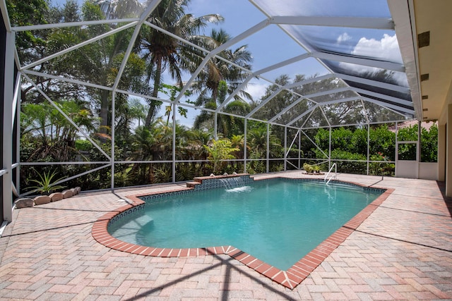 view of swimming pool featuring a patio, pool water feature, and a lanai