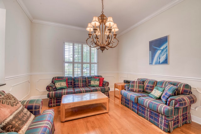 living room featuring ornamental molding, light hardwood / wood-style flooring, and an inviting chandelier