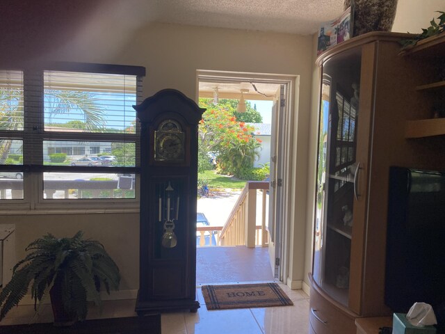 tiled foyer entrance with a textured ceiling