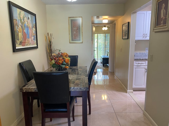 dining area featuring light tile patterned flooring